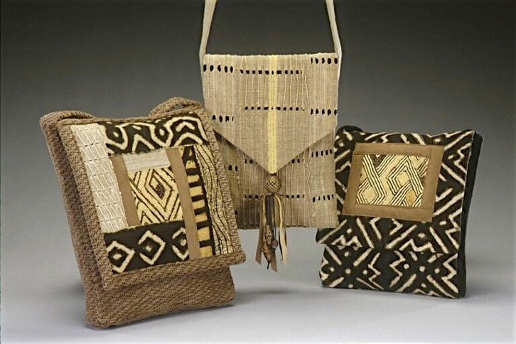 Three patchwork purses of Nigerian strip cloth, Malian mudcloth and raffia pile cloth from Zaire. By Viki Dyan.