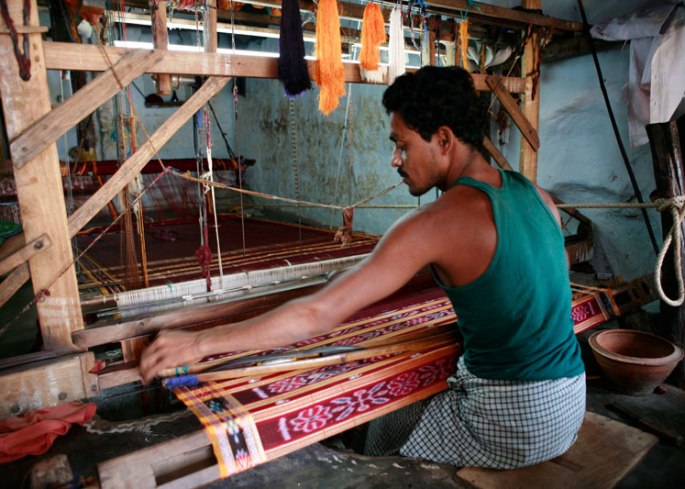 Man at loom weaving ikat, India