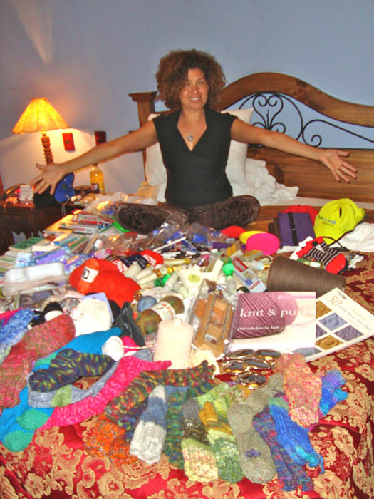 Claudia Avila, overjoyed at all the goodies donated for the remote Andean villages; Beverly's socks are in the foreground.