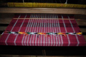 Loom with red weaving