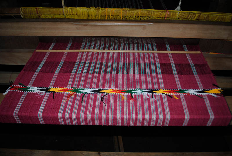Loom with red weaving