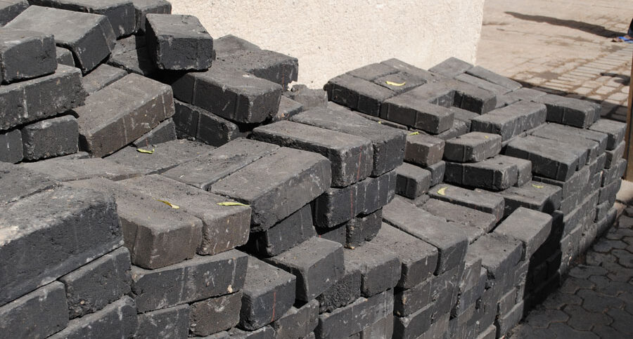 Pile of black bricks for street paving.