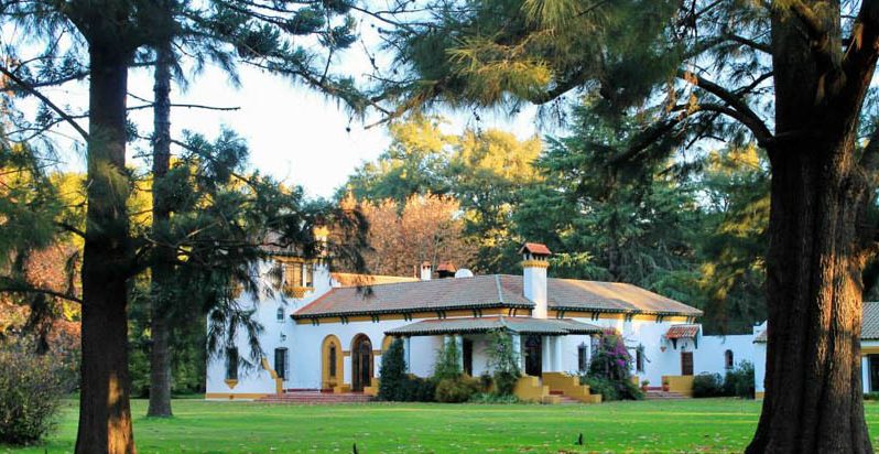 Country hacienda with tile roof, nestled among the trees near Buenos Aires.