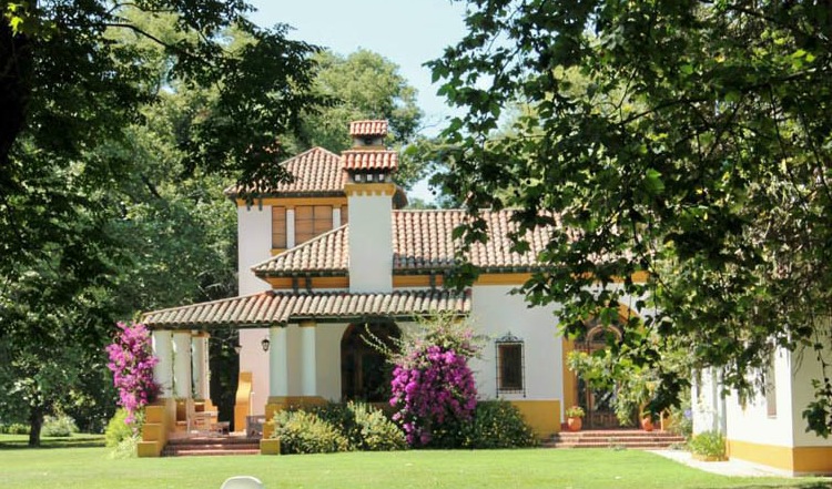 Spanish style hacienda surrounded by trees and walking trails.