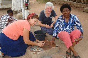 Women sitting down polishing beads Odumase-Krobo