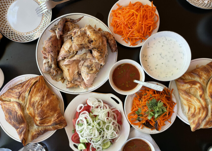 Uzbek meal of large samosas, carrot salad and chicken.