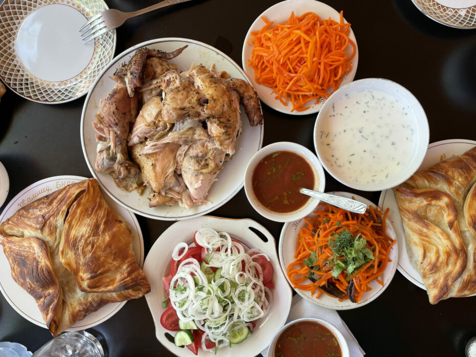 Uzbek meal of large samosas, carrot salad and chicken.