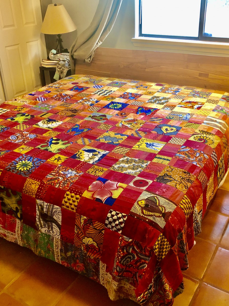 Partially completed quilt with printed fabrics from Ghana and Indonesian cotton batik cloth strips; by Cynthia Samake.