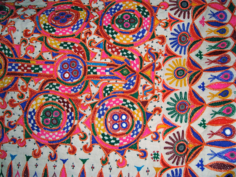 Detail of hand embroidert by Rabari women, multicolored thread on white cloth.