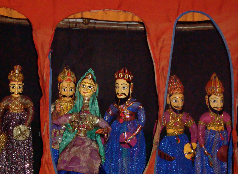 Four puppets at a restaurant that also has some performances.
