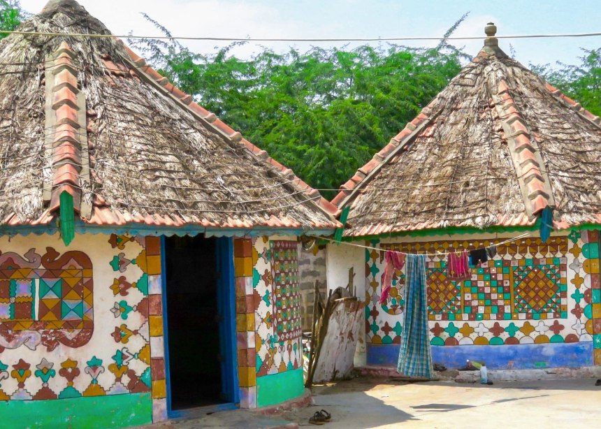 Decorated mud bungalows  with painted patterns on the walls.