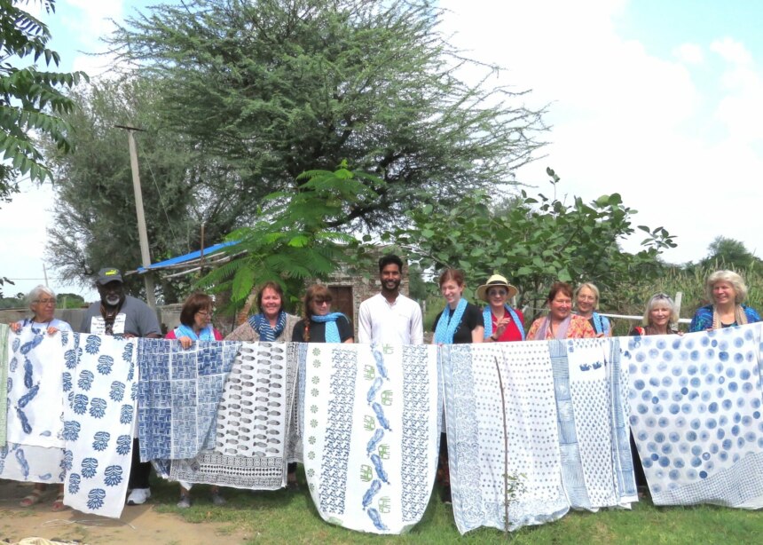 Group of people holding up their hand-printed cloths.