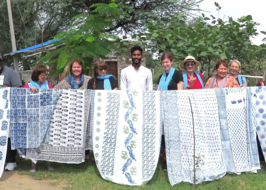 Group of people holding up their hand-printed cloths.