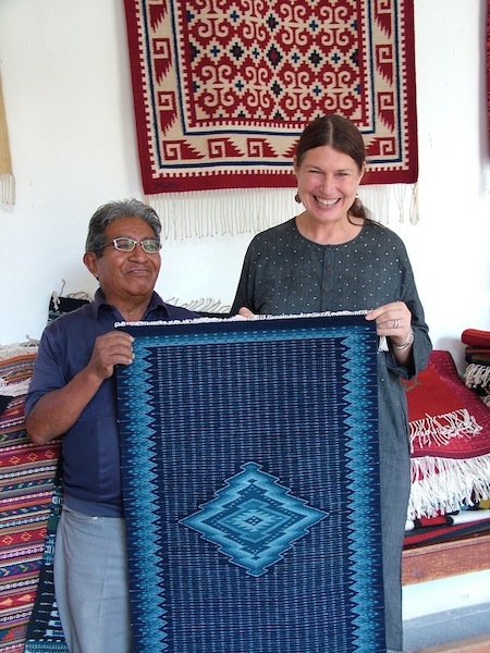 Chloe Sayer with weaver and rug.