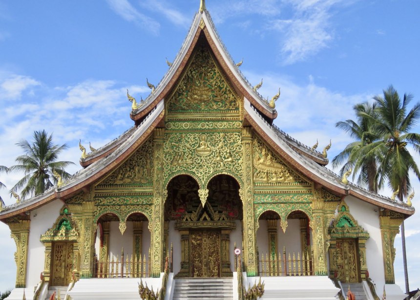 A large and highly decorated Buddhist temple with three layers of curved roofs.