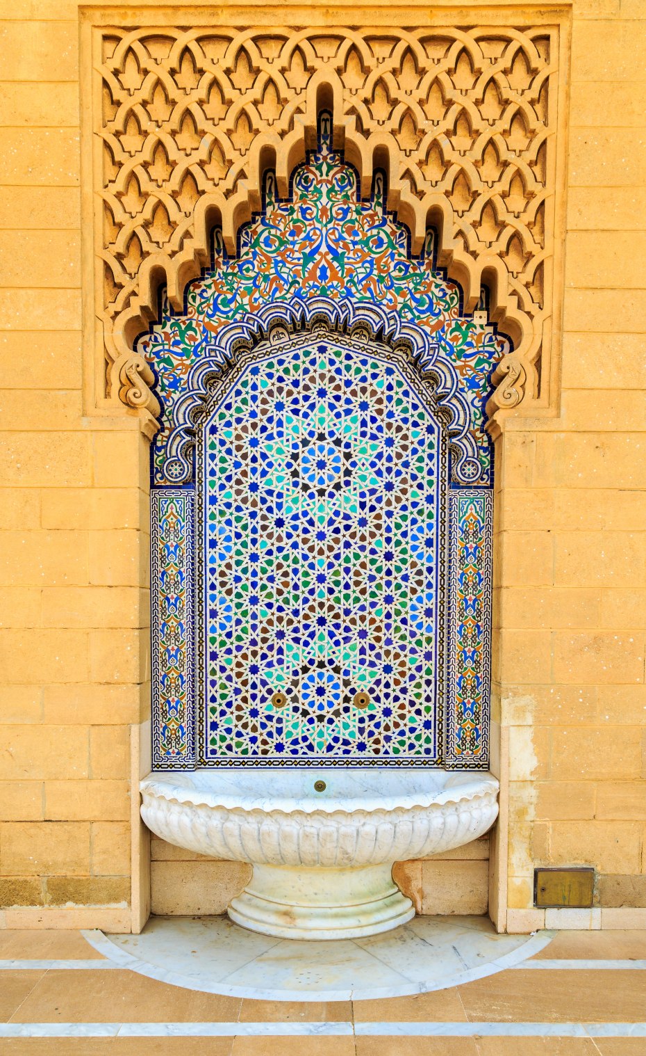 an outdoor moroccan style fountin with fine colorful mosaic tiles