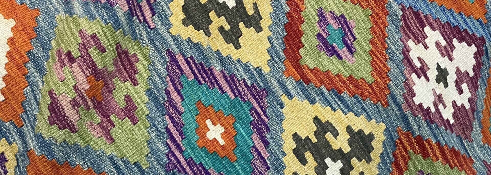 Ki lim (flat weave) rug detail with multicolored diamond shapes. Samarkand.