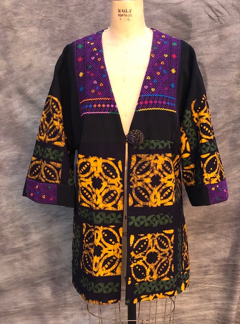 Wax-batik printed cotton fabrics in patchwork jacket by Suzi Click.