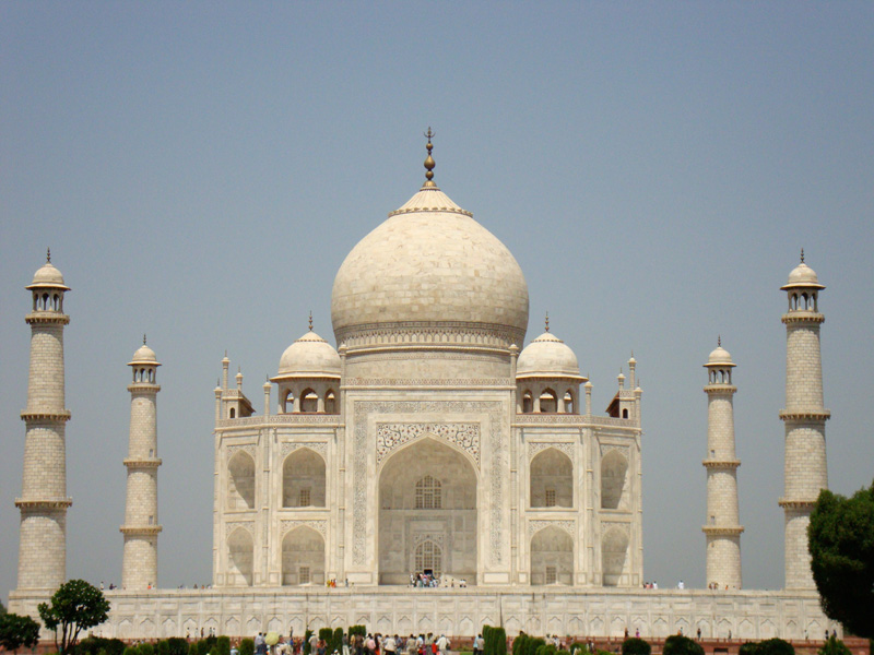 Enormous white building in India with domes and minarets.