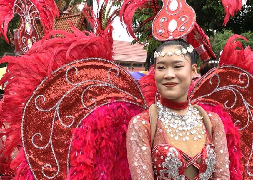 Fancy dancer in red outfit with red lamé wings at Candle Festival, UBON.