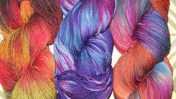 Three skeins of hand-dyed yarn.